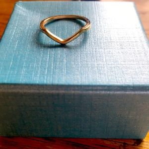 A gold ring with a dip in the middle